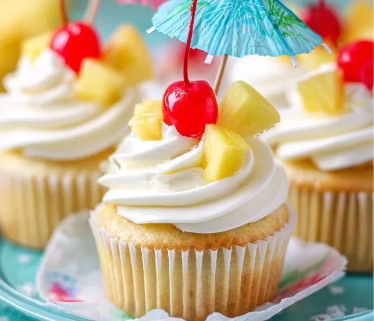 Delicious Piña Colada cupcakes topped with coconut and pineapple frosting